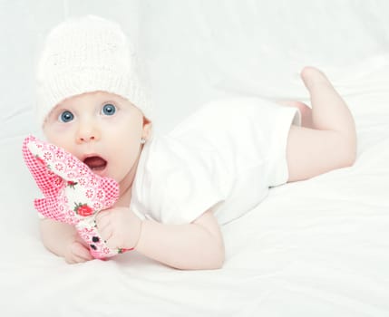 Cute Baby in Knitted Cap Girl Playing With Toy