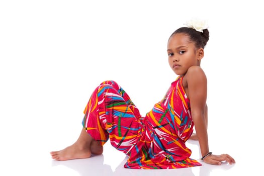 Portrait of a cute young African Asian girl seated on the floor