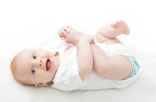 Cute Baby Girl Playing With Her Toes on White Background