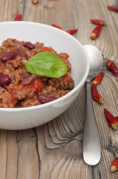 Chilli Con Carne in White Bowl and Red Chili Peppers
