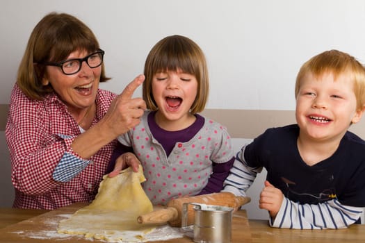 Grandma and her grandchildren have a lot of fun baking