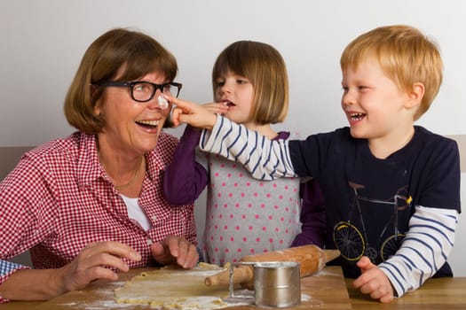 Grandma and her grandchildren baking