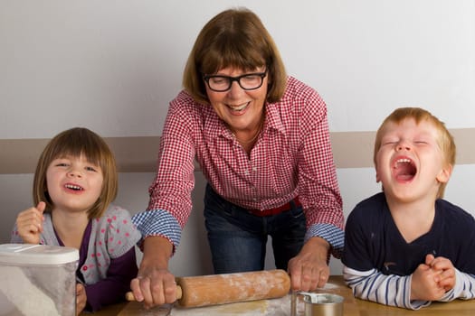 Grandma and her grandchildren baking