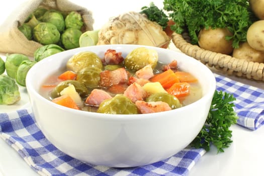 a bowl of Brussels sprout stew with colorful vegetables and bacon