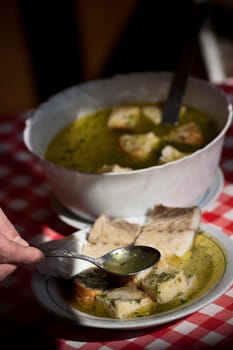 Real food photographed on location in traditional portuguese restaurants, soup with codfish - açorda de bacalhau - Alentejo, Portugal