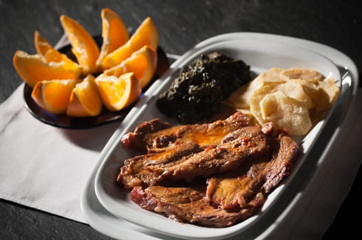 Real food photographed on location in traditional portuguese restaurants, pork fillet seasoned with red bell pepper garnished with mashed spinach, Alentejo, Portugal