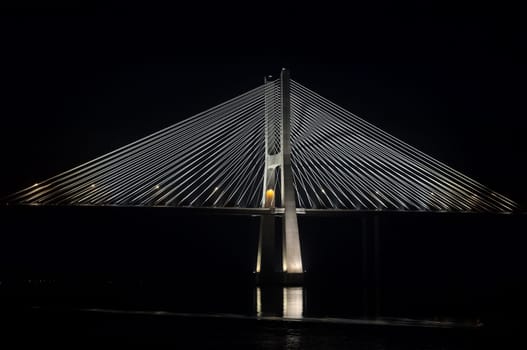 Vasco da Gama bridge over Tagus river in a dark night, Lisbon, Portugal