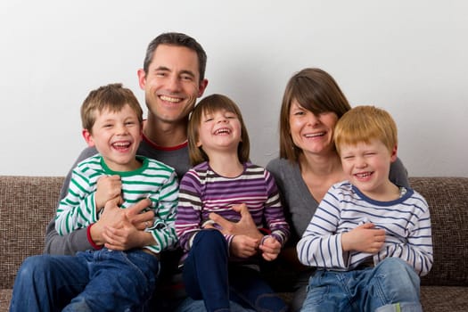 Laughing family on the sofa