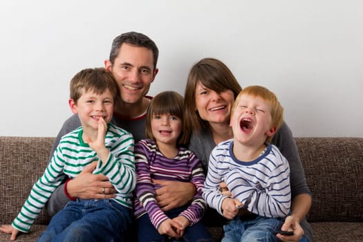 Laughing family on the sofa