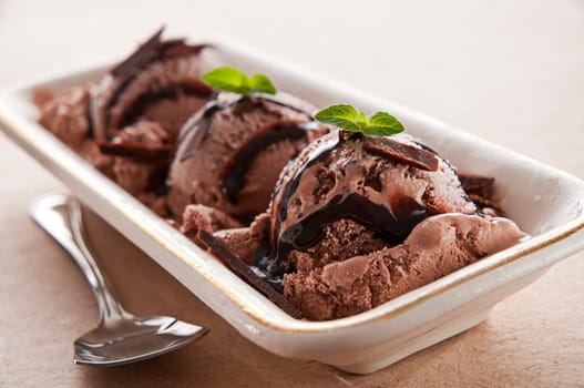 Chocolate ice cream with syrup close up