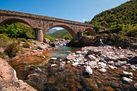 Stone bridge over the river in Corsica
