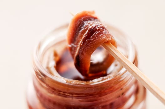 Fresh anchovie on toothpick close up shoot