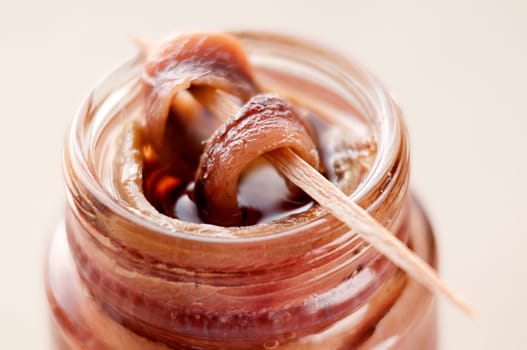Fresh anchovies on toothpick close up shoot