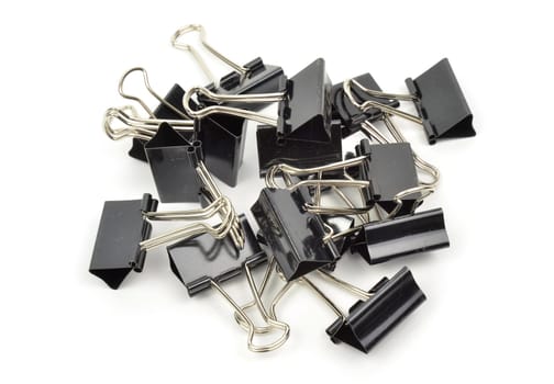 A black binder clip against a white background