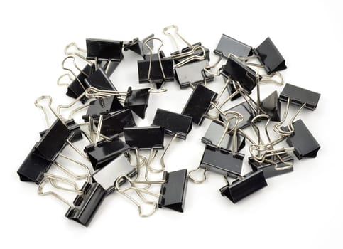 A black binder clip against a white background