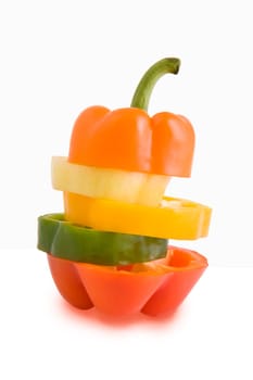 Mixed pieces of different colored paprikas, vegetable isolated on white