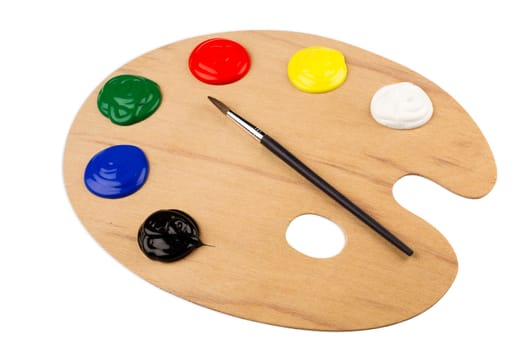 Wooden color palette with paint and brush.