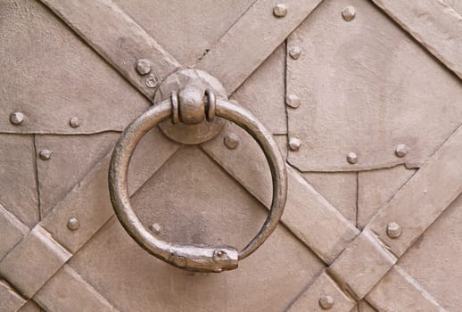 Steel knocker on the old rustic historic door