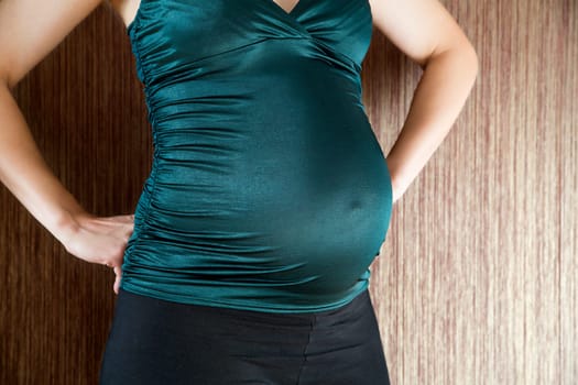 Zoomed pregnant woman belly before coming child birth