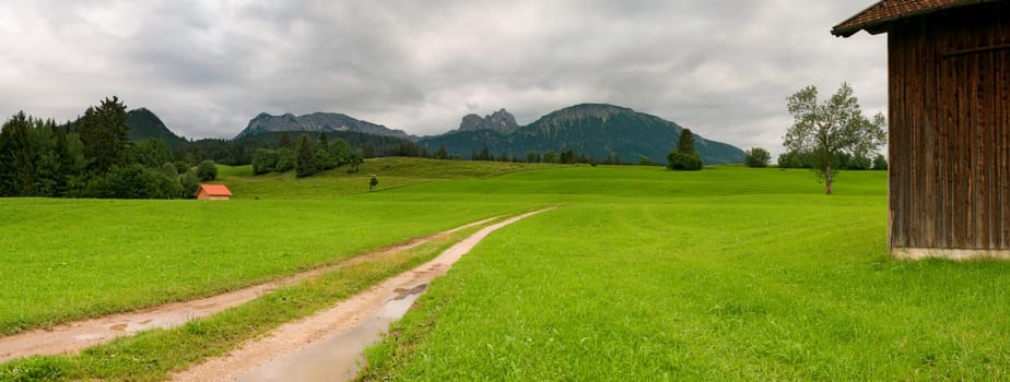 Panoramic picture in the Allgäu / Bavaria with overcast skies in summer  panoramic composed from multiple images
