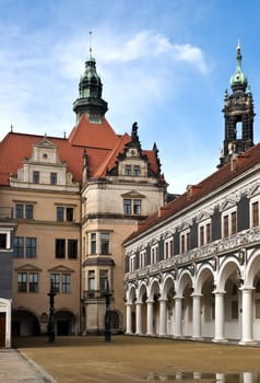 The historic Stall Courtyard and parts of the exquisite Royal Palace in Dresden against a nice blue sky with some white cloud.