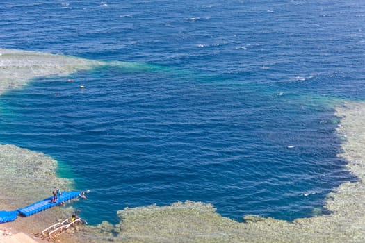 Blue Hole is a popular diving location on east Sinai, a few kilometres north of Dahab, Egypt on the coast of the Red Sea.