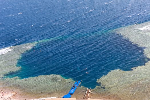 Blue Hole is a popular diving location on east Sinai, a few kilometres north of Dahab, Egypt on the coast of the Red Sea.