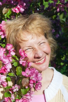 a middle-aged woman in a blossoming magnolias