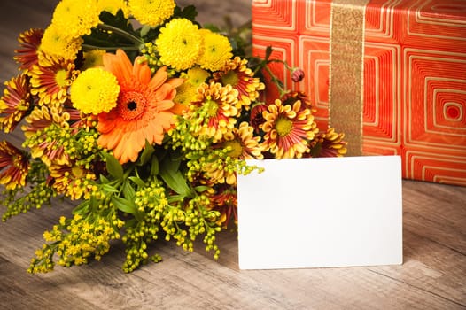 box with a gift and a bouquet of flowers