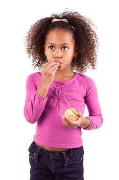 Little African Asian girl eating a tangerine ,isolated on white background