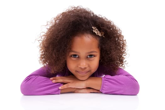 Portrait of a cute little African Asian girl lying down on the floor