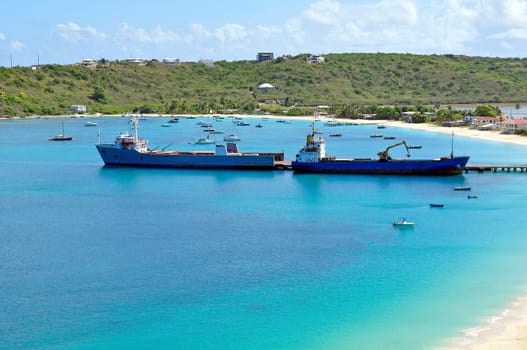 Two ships offloading cargo at caribbean port.