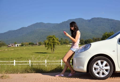 pretty women use her phone in the country