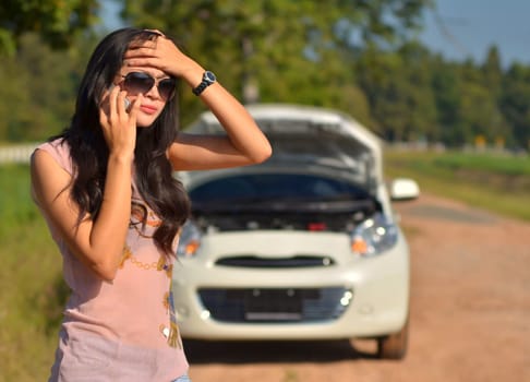 A woman calls for assistance  after her car broke down