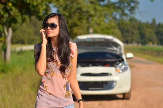 A woman calls for assistance  after her car broke down