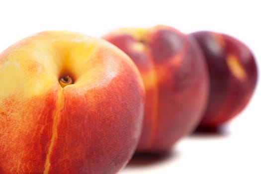 Three fresh nectarines on an isolated background