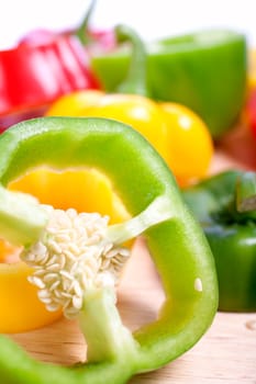 Red Yellow and Green peppers sliced on an isolated white background