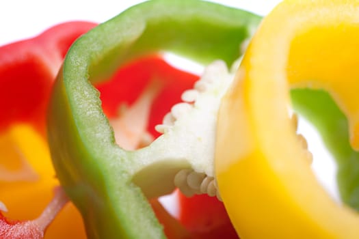 Red Yellow and Green peppers sliced on an isolated white background