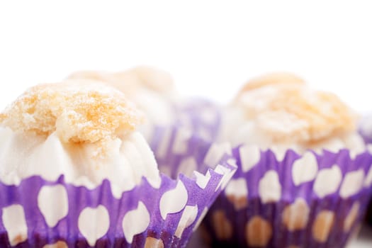 Freshly baked cup cakes with cream filling in cake trays