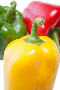 Red Yellow and Green peppers laid out next to each other