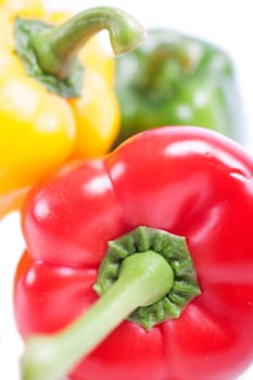 Red Yellow and Green peppers laid out next to each other