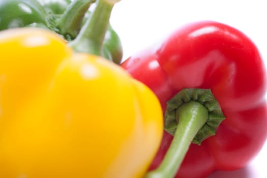 Red Yellow and Green peppers laid out next to each other