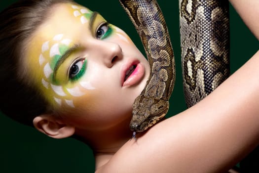 Beautify female with a snake (python) - circus performance