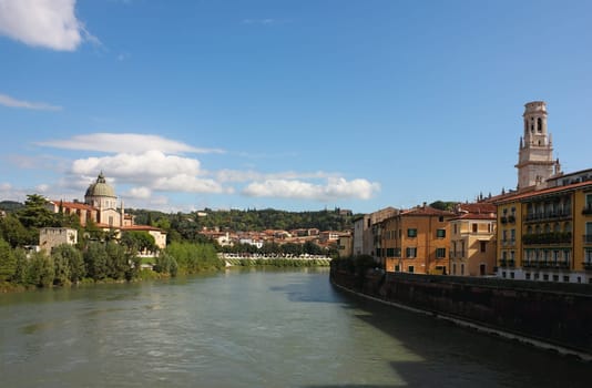 River Adige view in Verona toward the Dome belltower and church San Giorgio. Shot in a bright sunny day over a blue sky.