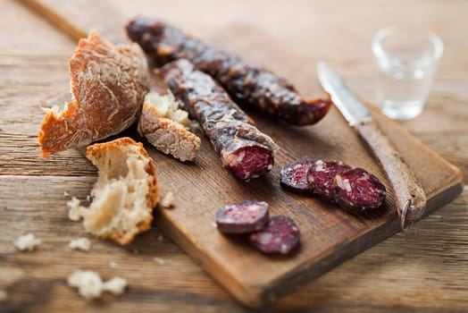Tasty salami sliced with bread close up shoot