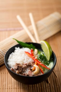Chinese soup with rice, beef and vegetables close up