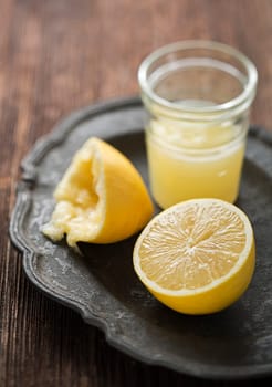 Freshly squeezed lemon on vintage plate close up