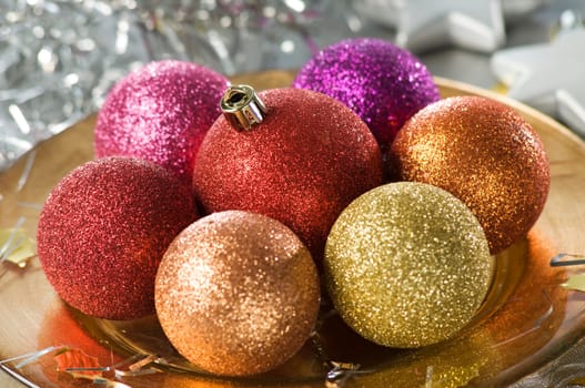 christmas ornaments on golden plate close up shoot