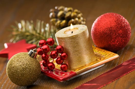 golden candle with christmas ornaments close up shoot