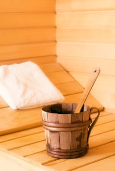 wooden bowl with spoon in sauna close up